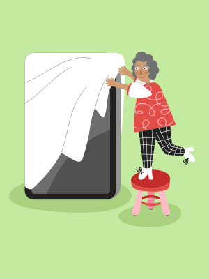 A woman standing on top of a stool next to a giant phone