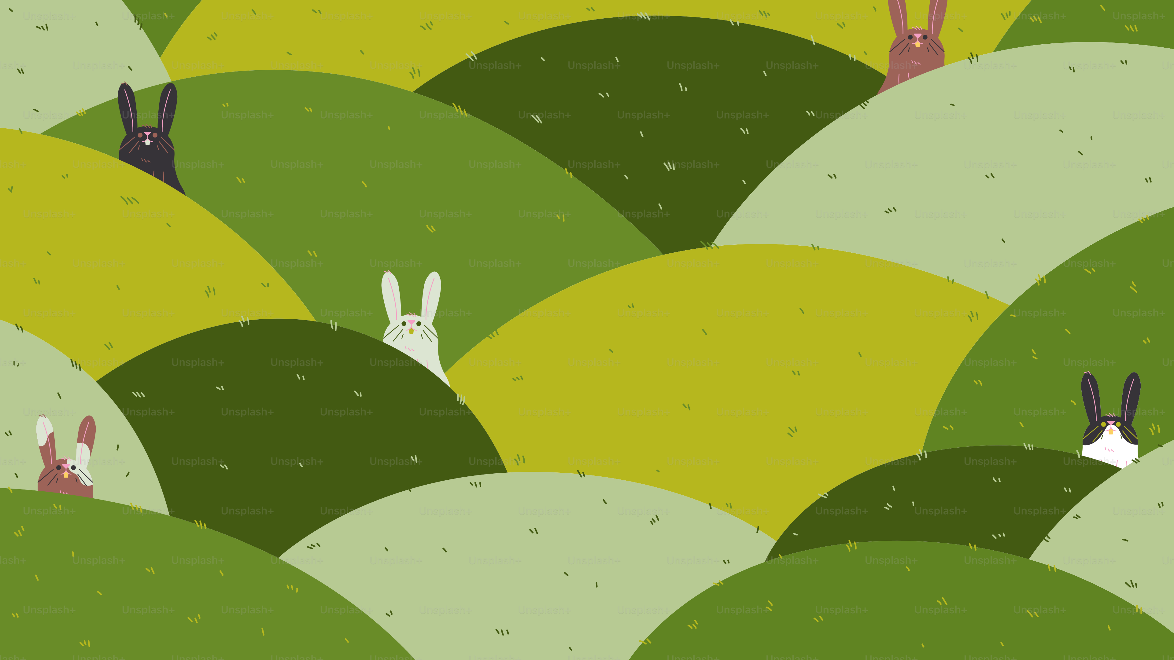 緑の丘の上に立つウサギの群れ