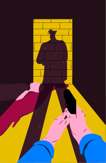 A person standing in front of a brick wall