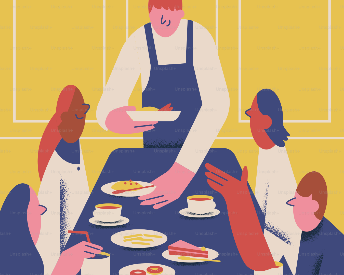 A group of people sitting at a table with plates of food