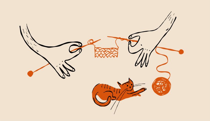 Cat plays with yarn while someone knits.