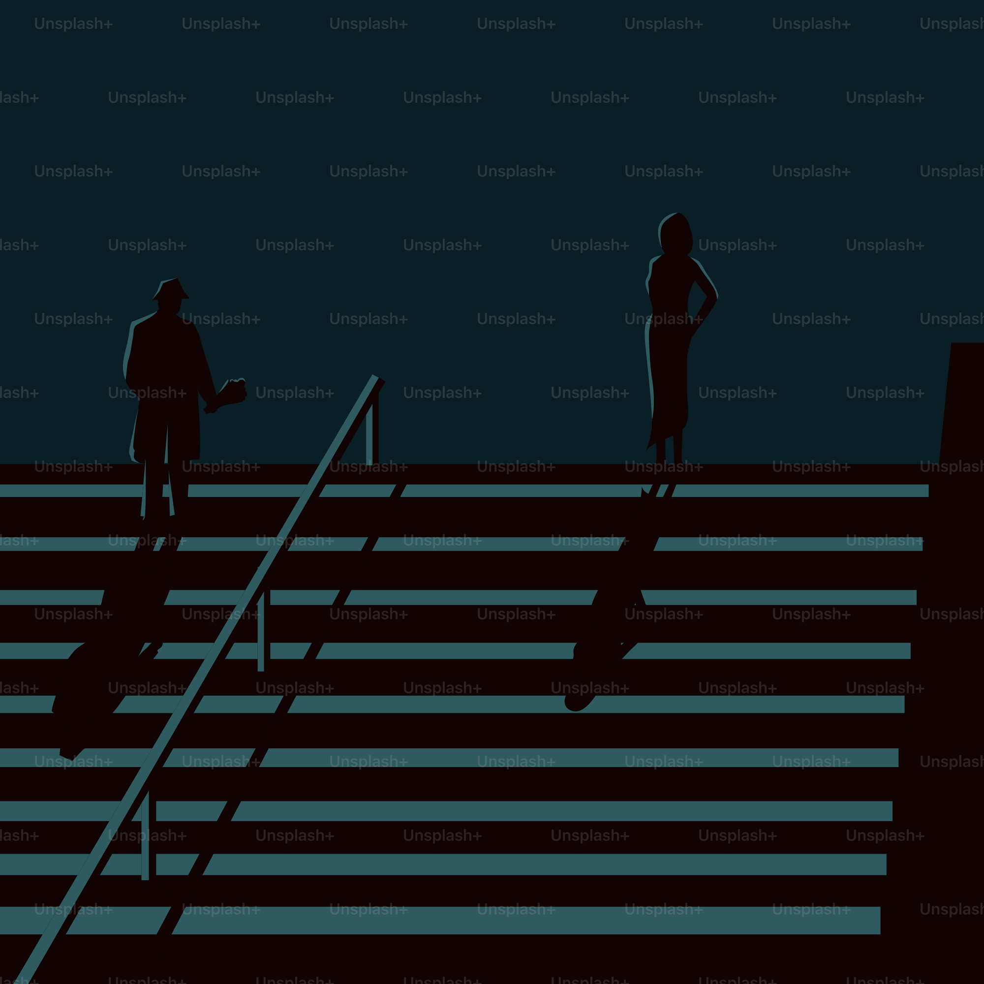 Two silhouetted figures stand on an illuminated staircase.