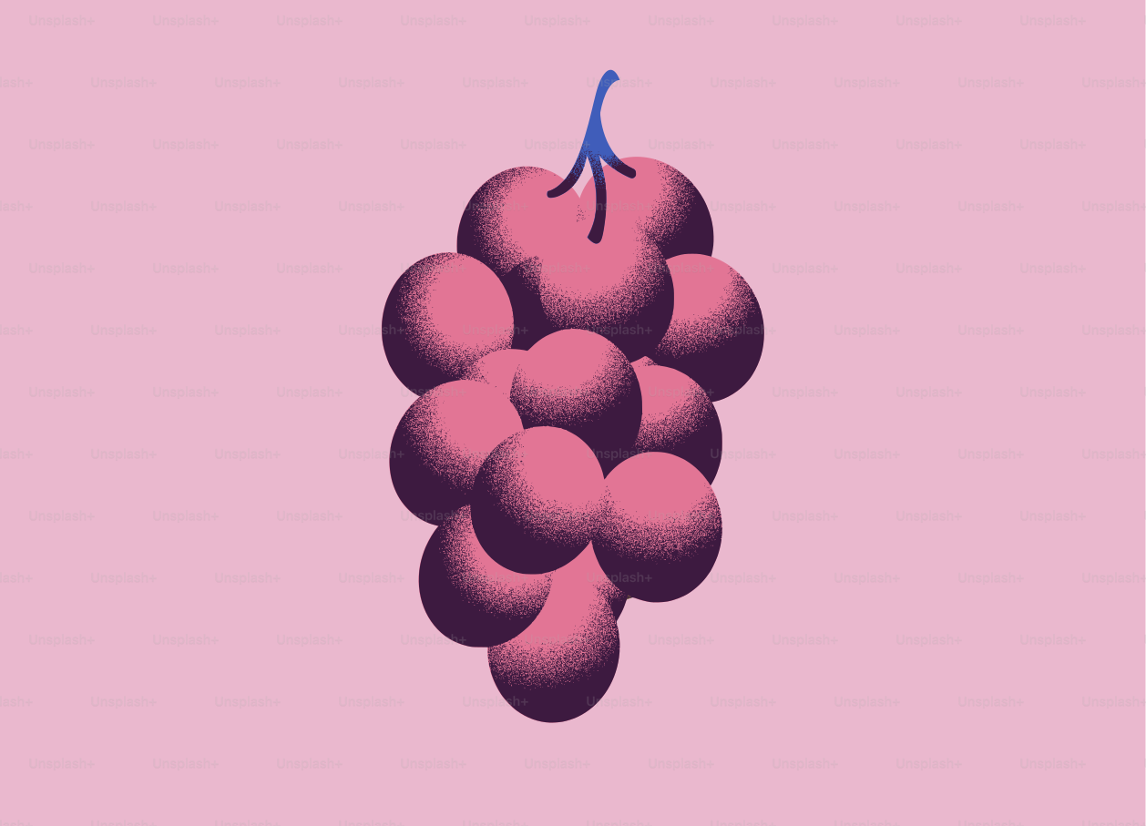 Un racimo de uvas sobre un fondo rosa.