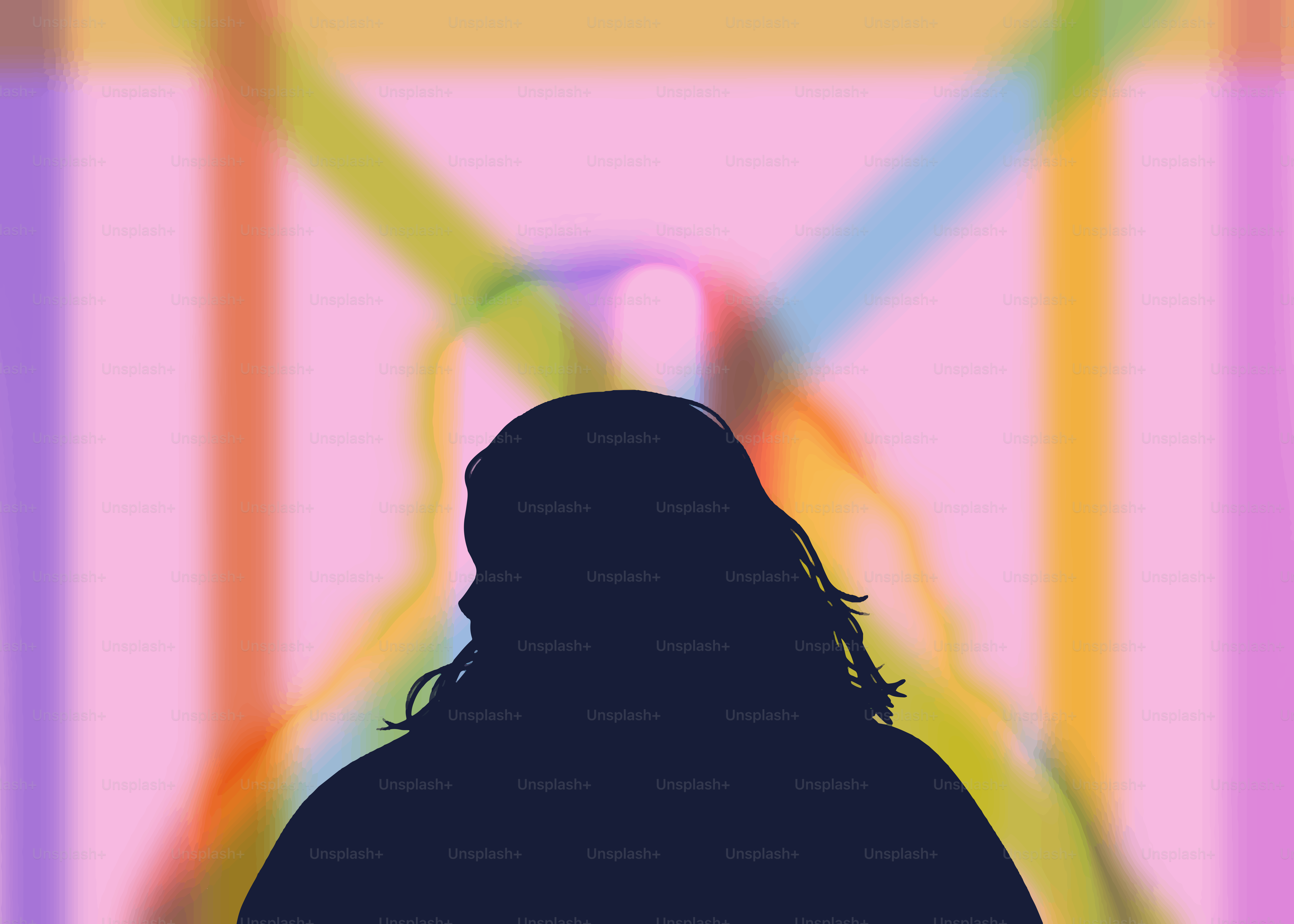 Silhouette of a person with colorful, blurred background.