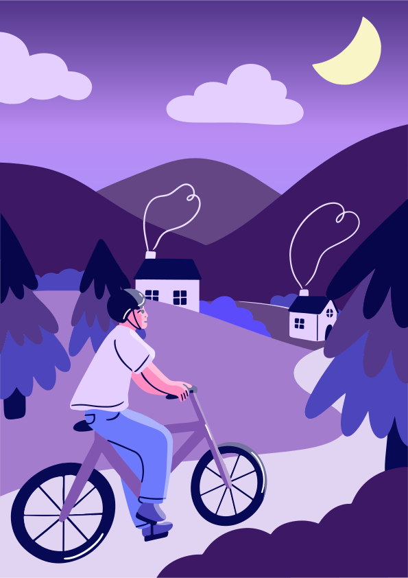 Un ciclista pasa por delante de las casas por la noche.