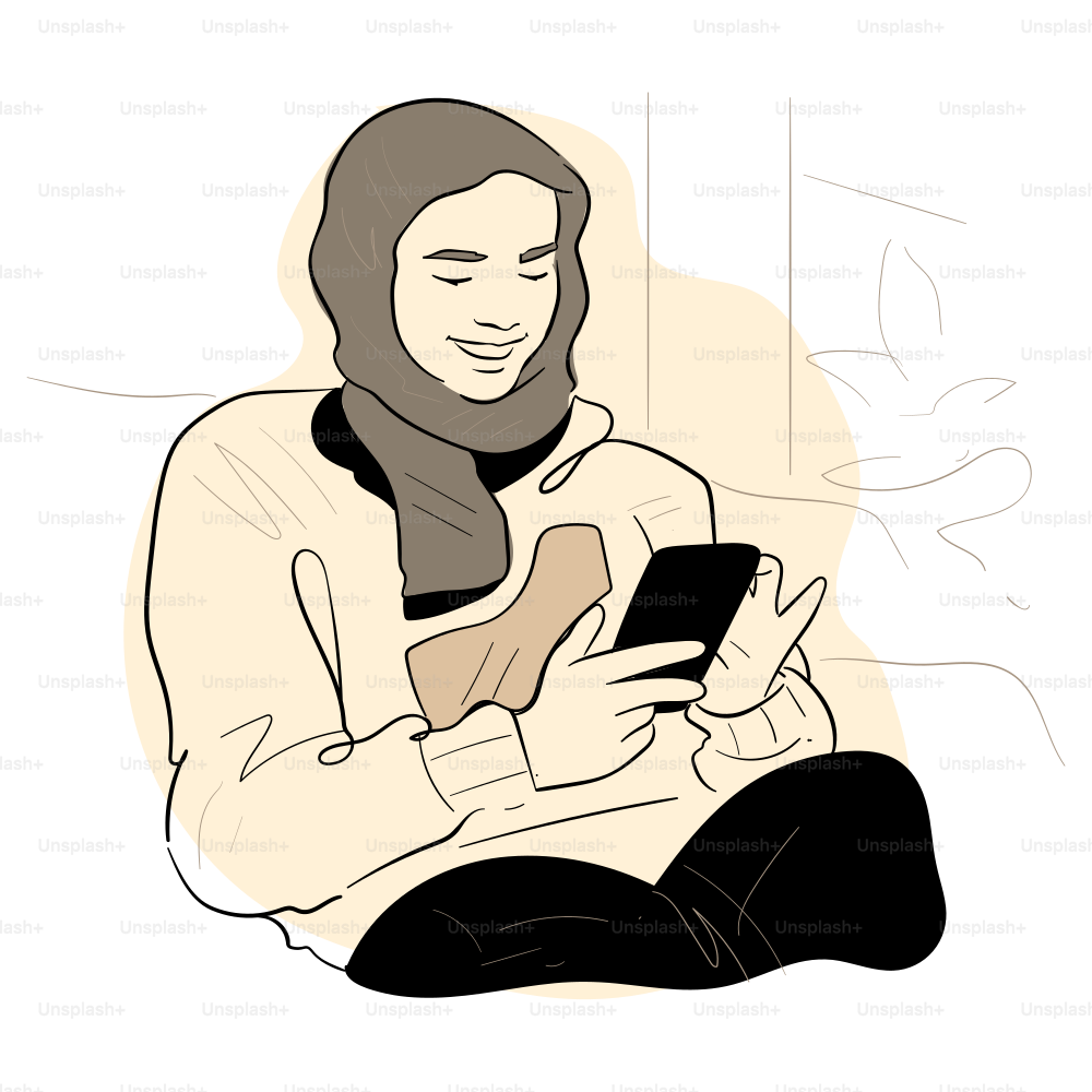 A woman smiles while looking at her phone.