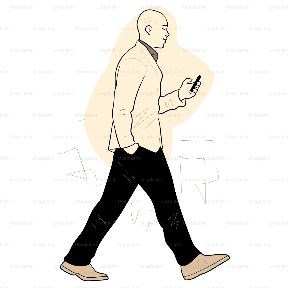 A man walks while looking at his phone.