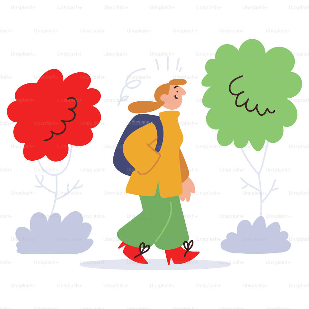 A person walks between two colorful trees.