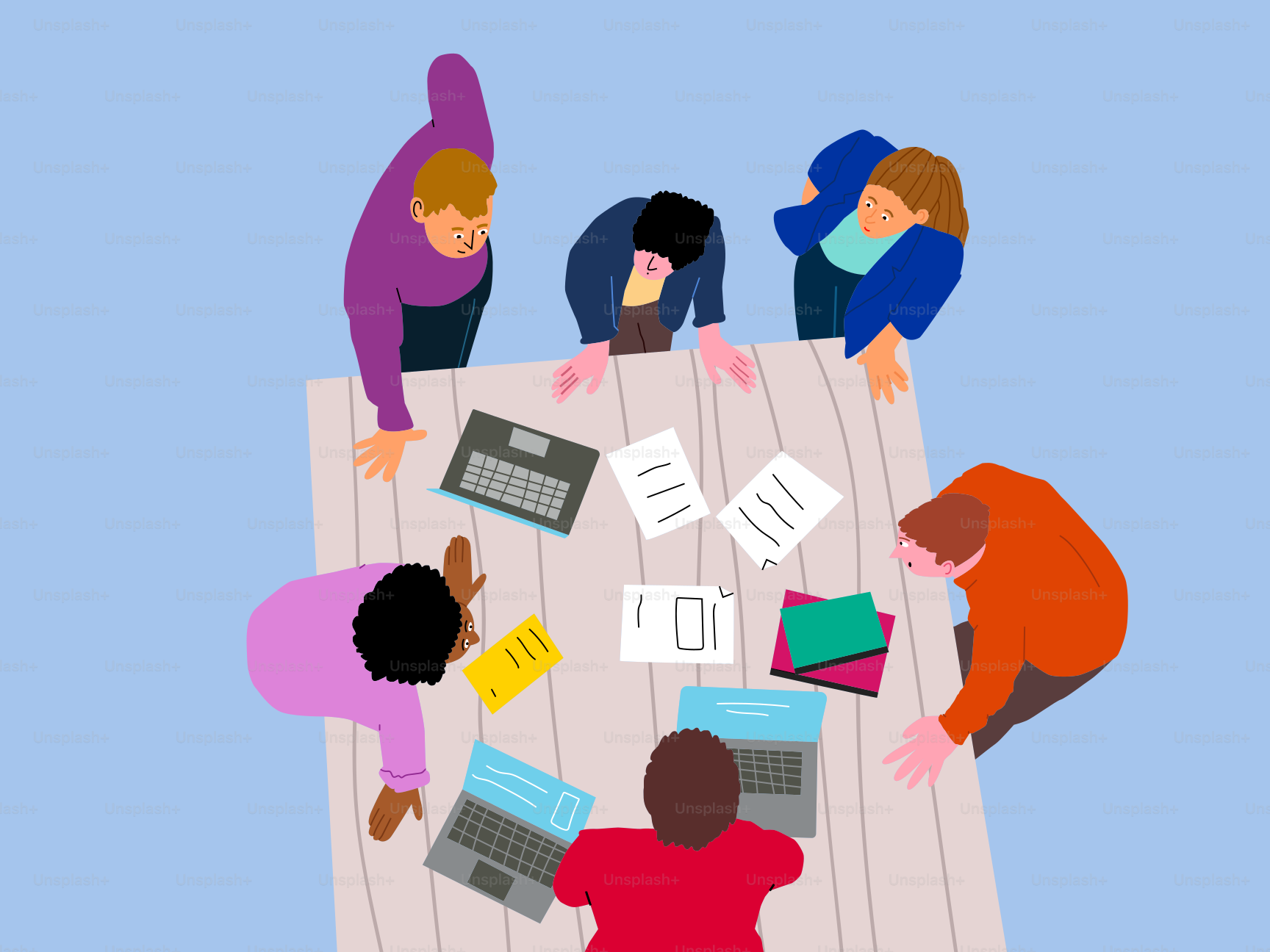 People gather around a table during a meeting.