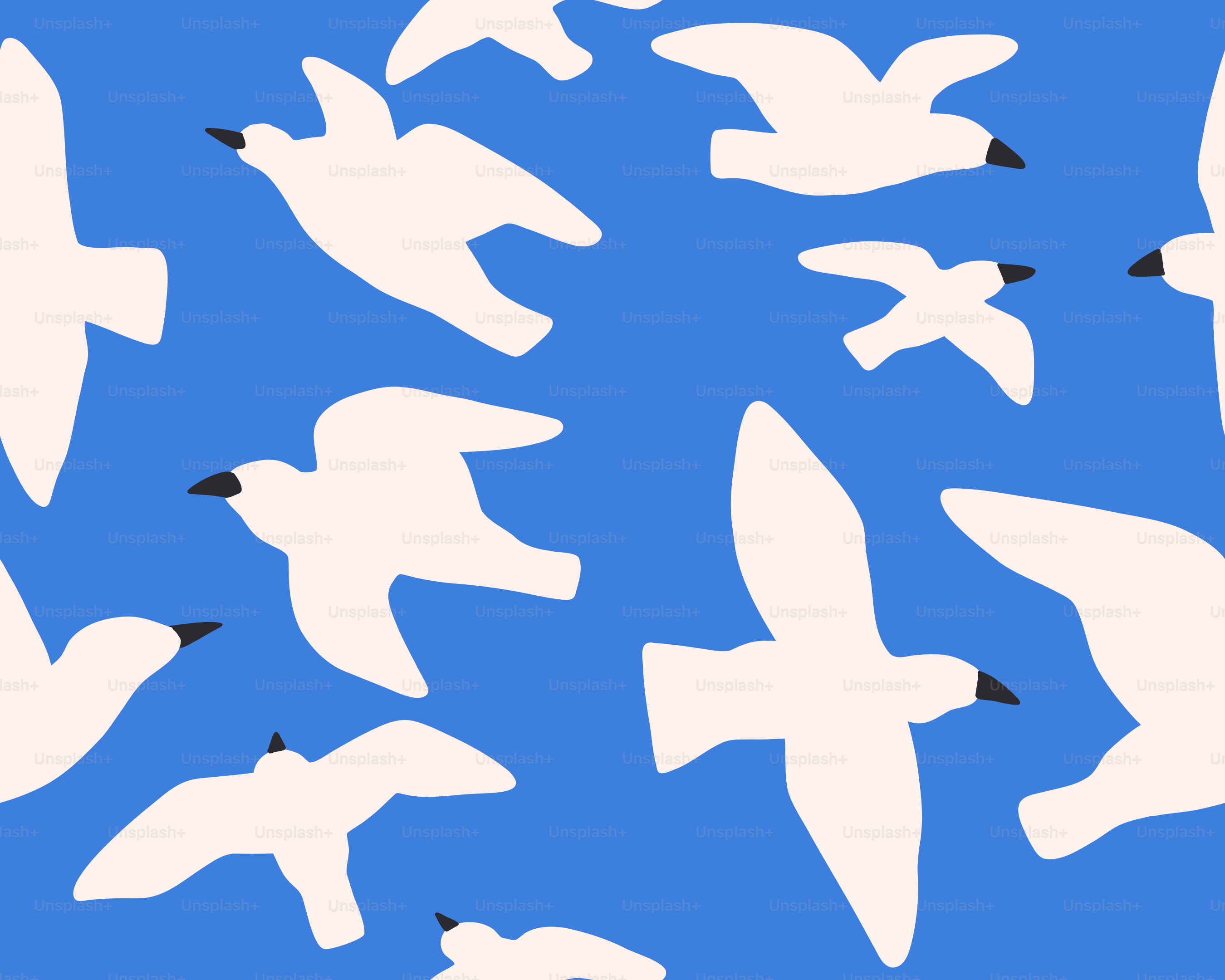 White birds are flying in a bright blue sky.