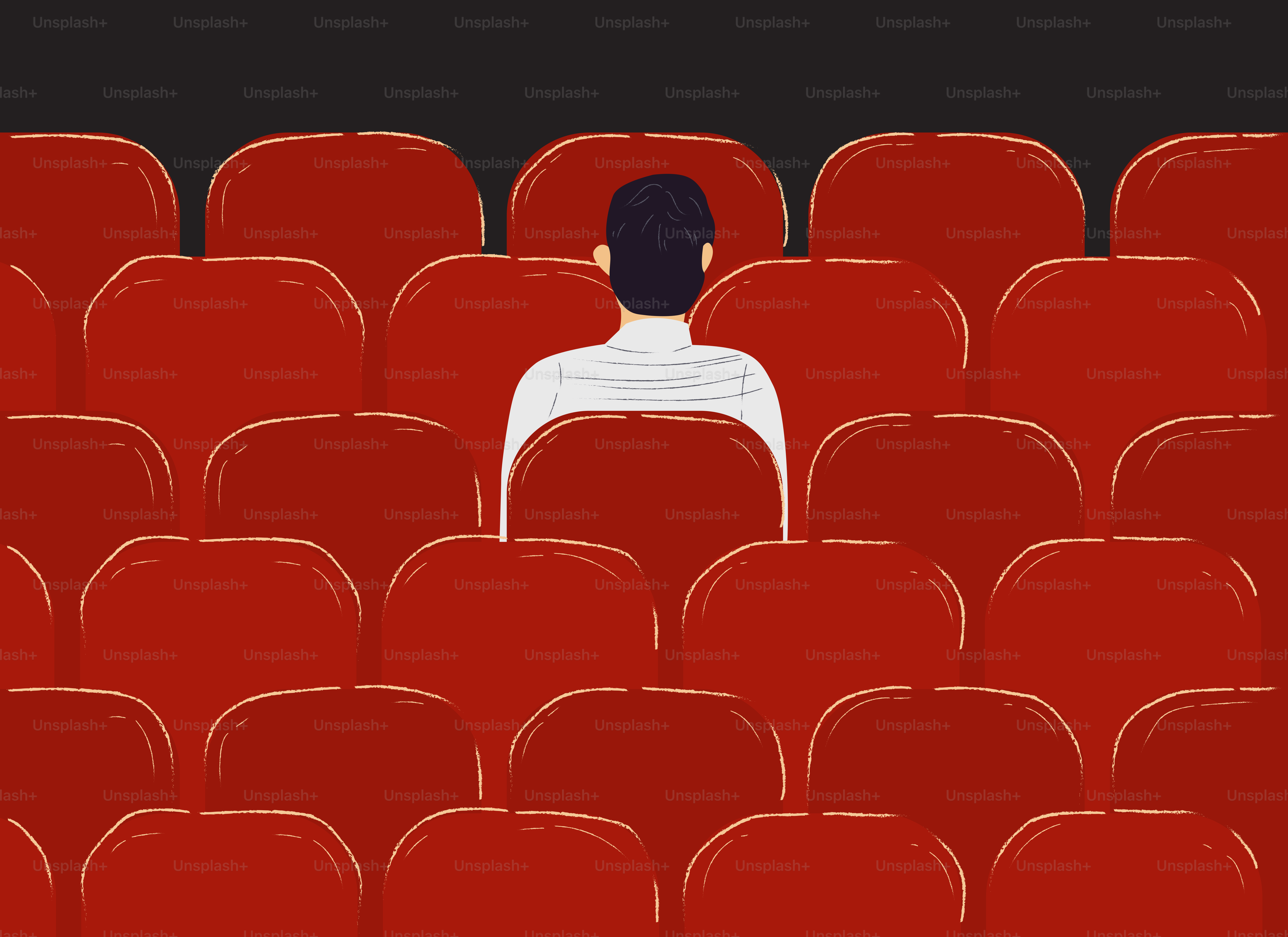 Una persona solitaria se sienta en un teatro vacío.