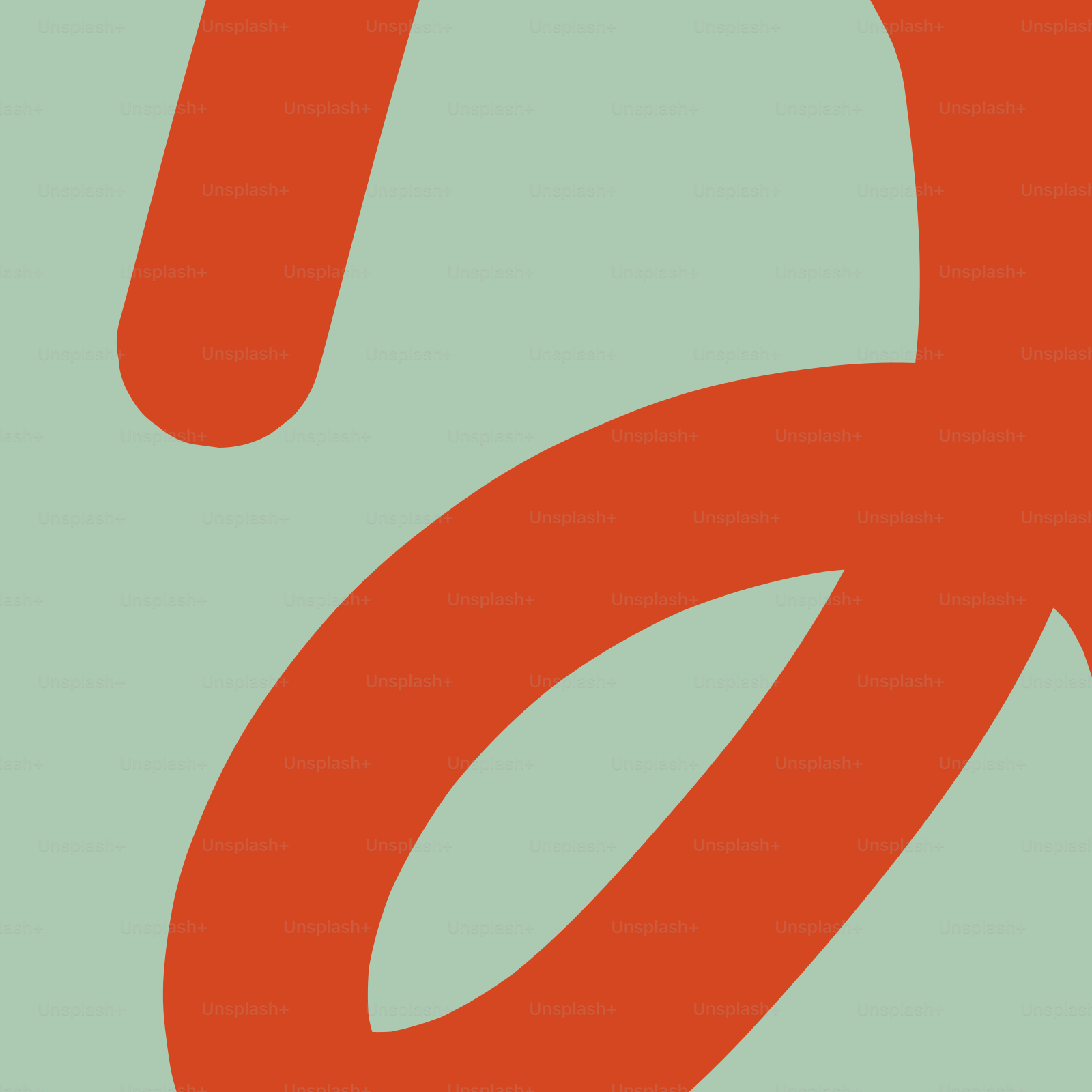 Écriture cursive orange sur fond vert pâle