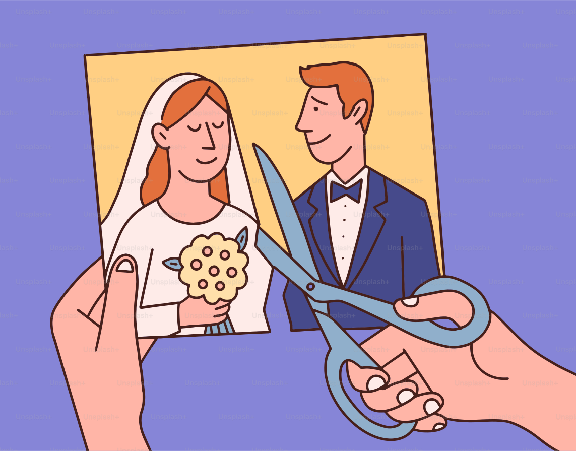 Hands cutting a wedding photo with scissors