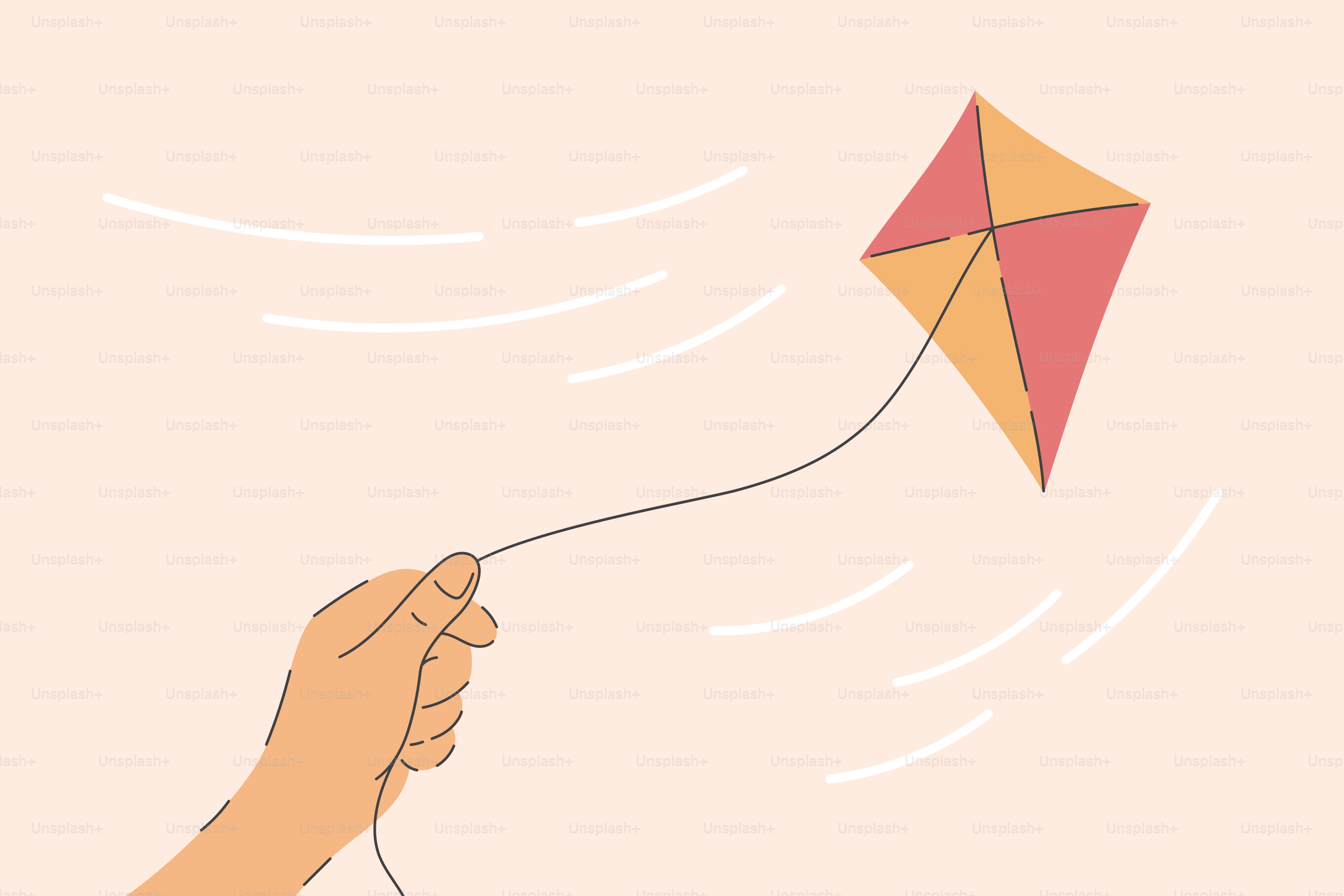 Hand holding a kite flying in the wind