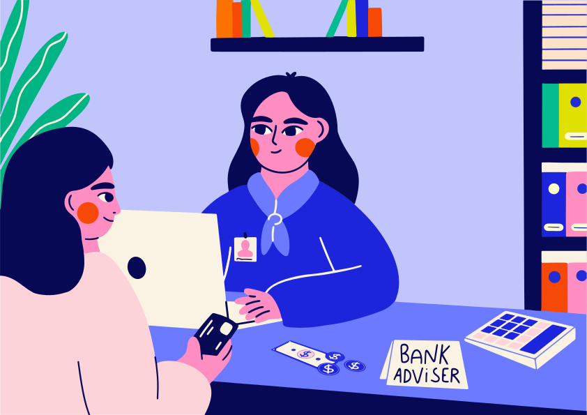 Bank adviser assisting customer at desk with credit card.
