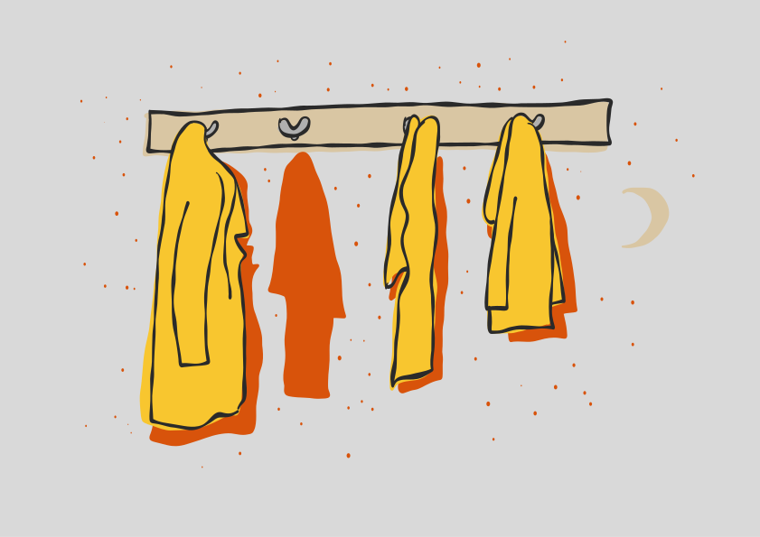 Yellow coats hanging on a wall rack