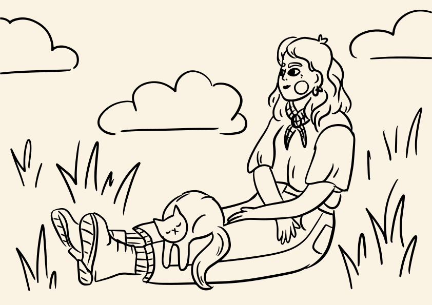 Woman sitting in grass with a cat