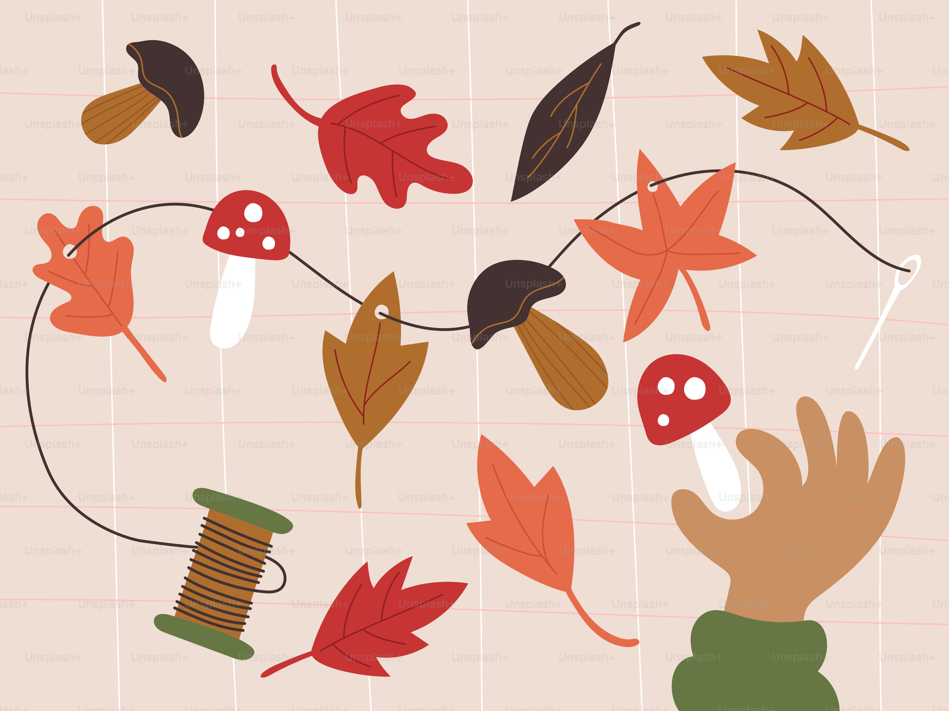 Hand stringing autumn leaves and mushrooms on a garland
