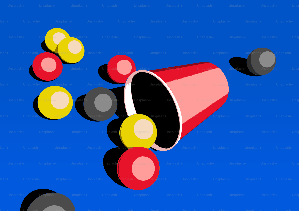 赤いカップは青い表面にカラフルなボールをこぼします。