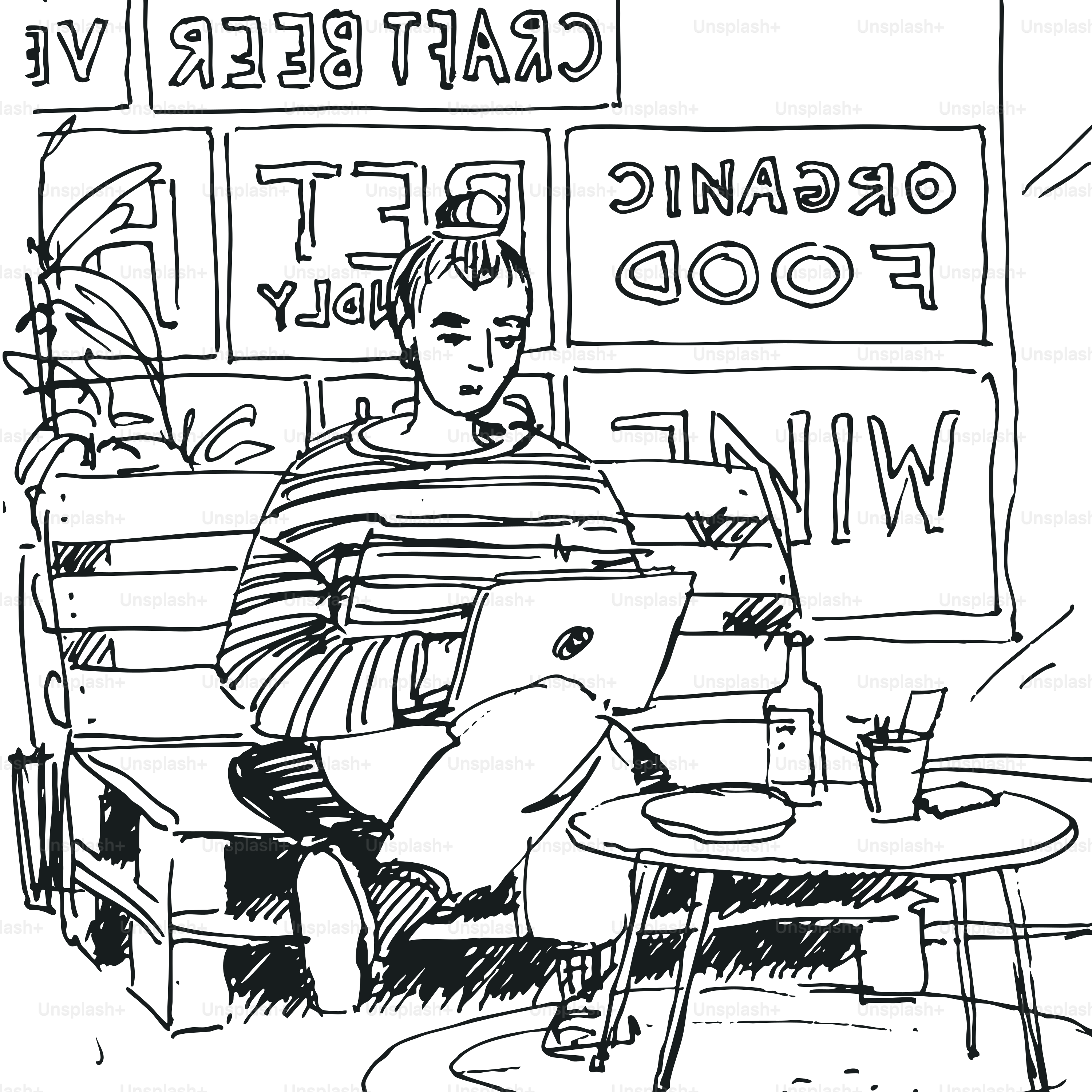 Personne travaillant sur un ordinateur portable à une table de café.