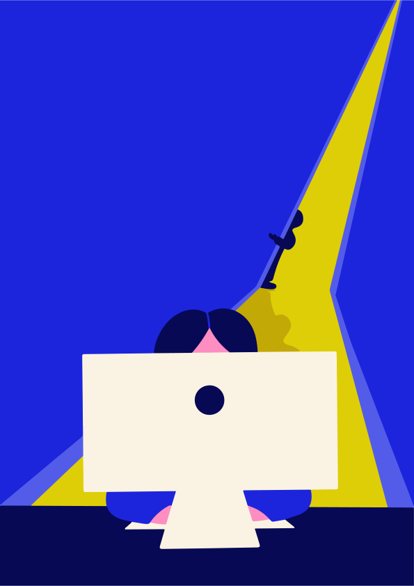 Person working on a computer under a spotlight.