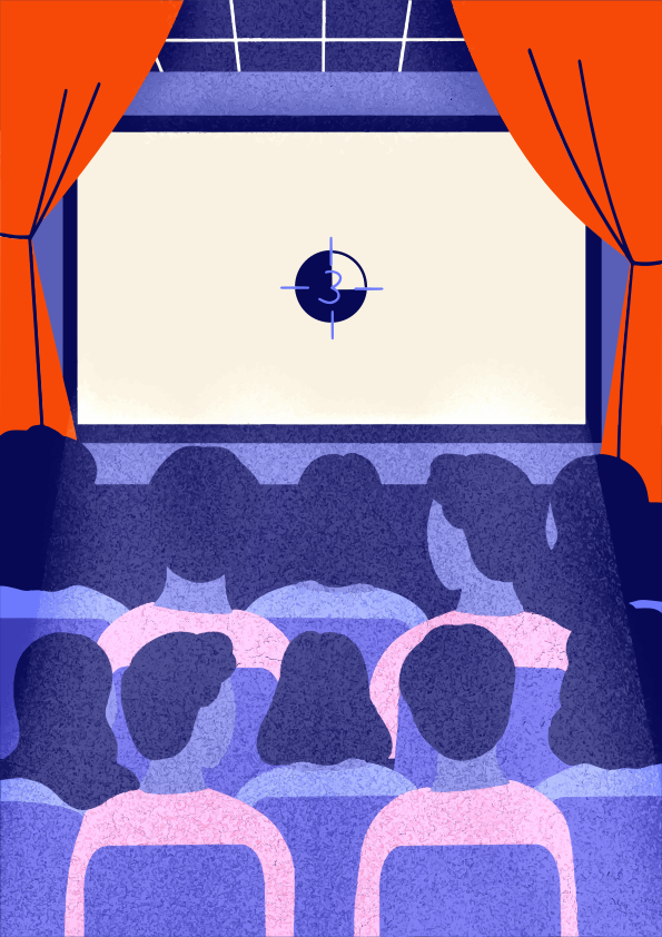 People watching a movie in a dark theater.