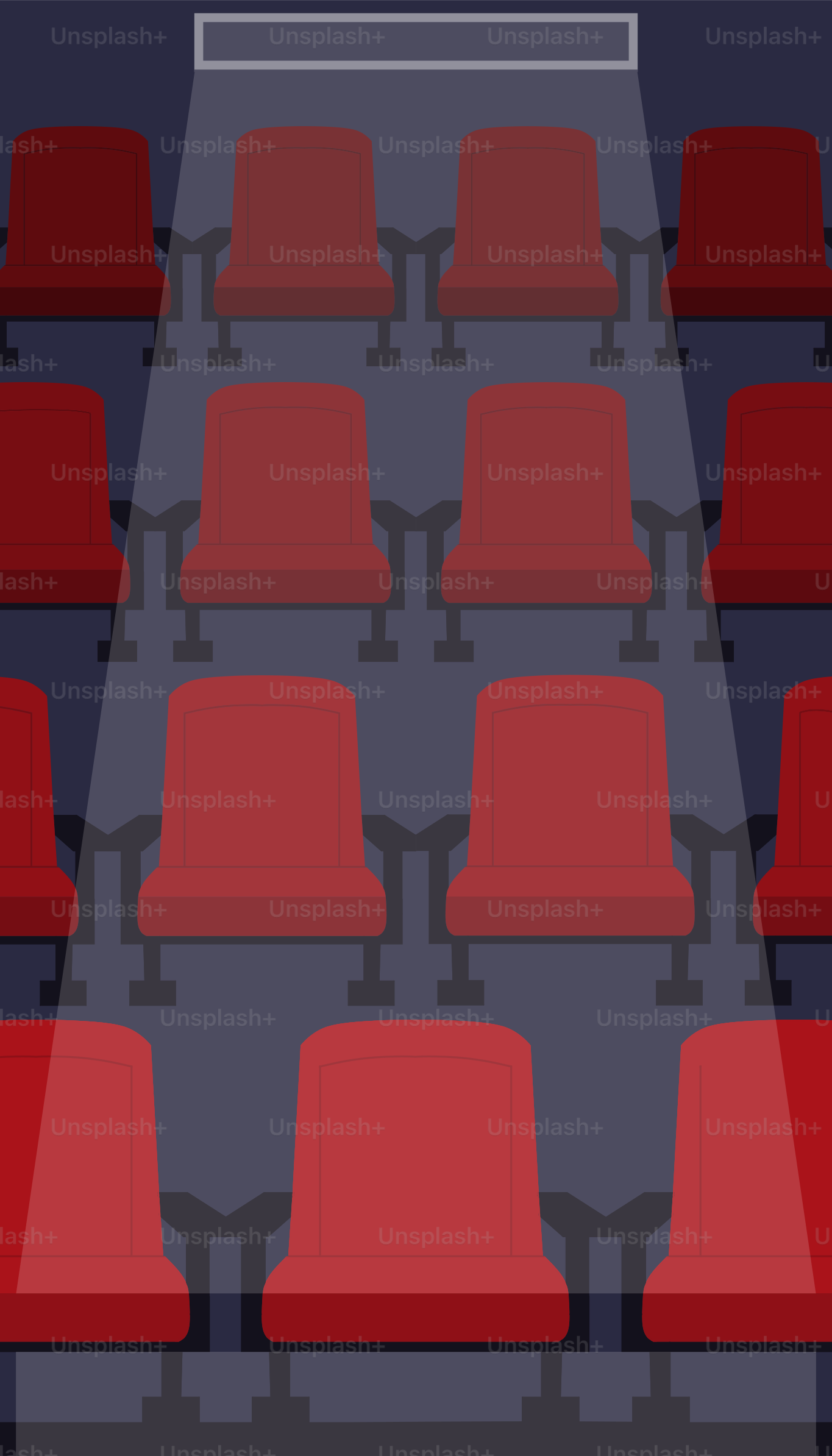 Empty red seats in a dark theater with spotlight.