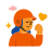 Person in orange helmet with closed eyes and fist pump