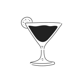 A martini glass with dark liquid and lime garnish