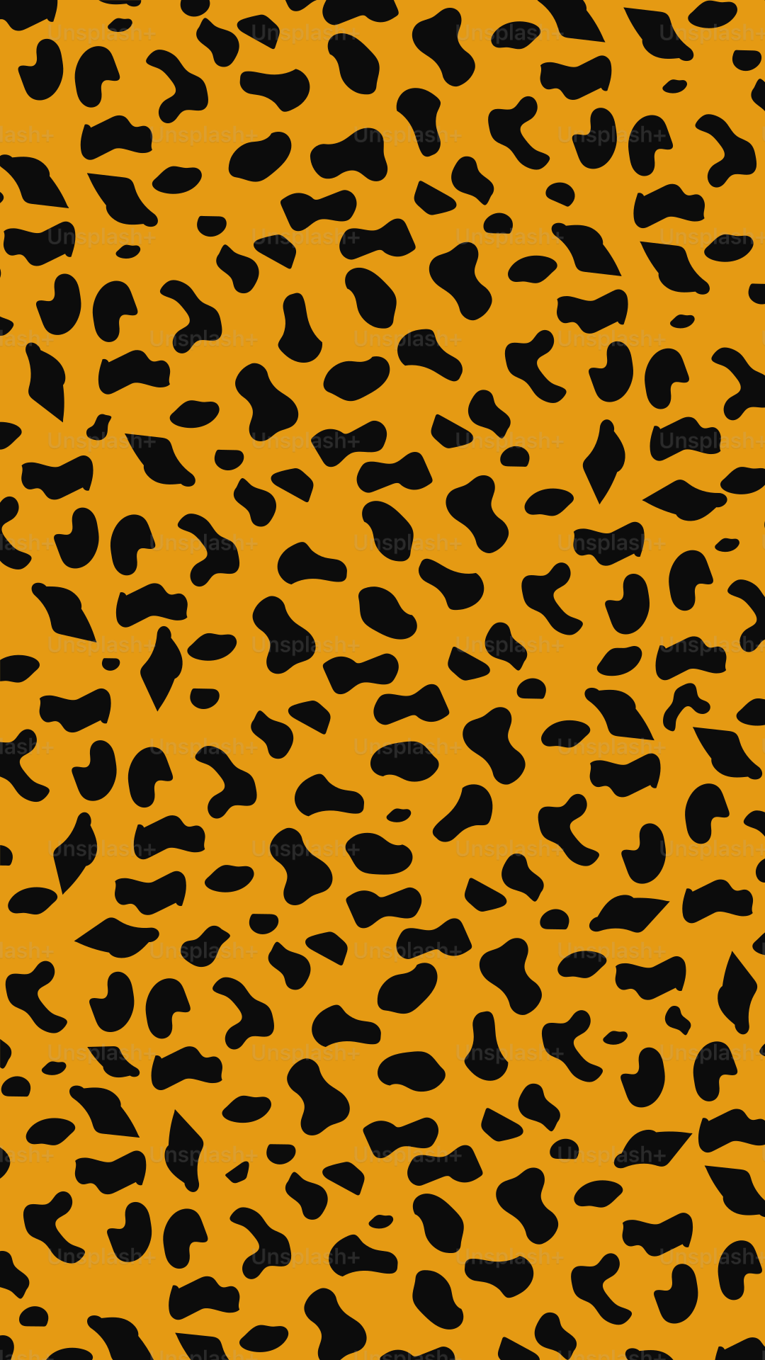 A leopard print pattern with black spots on orange.