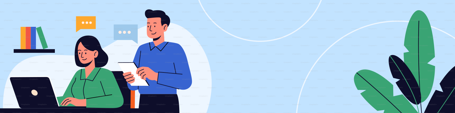 Two people collaborating at a desk with a laptop.