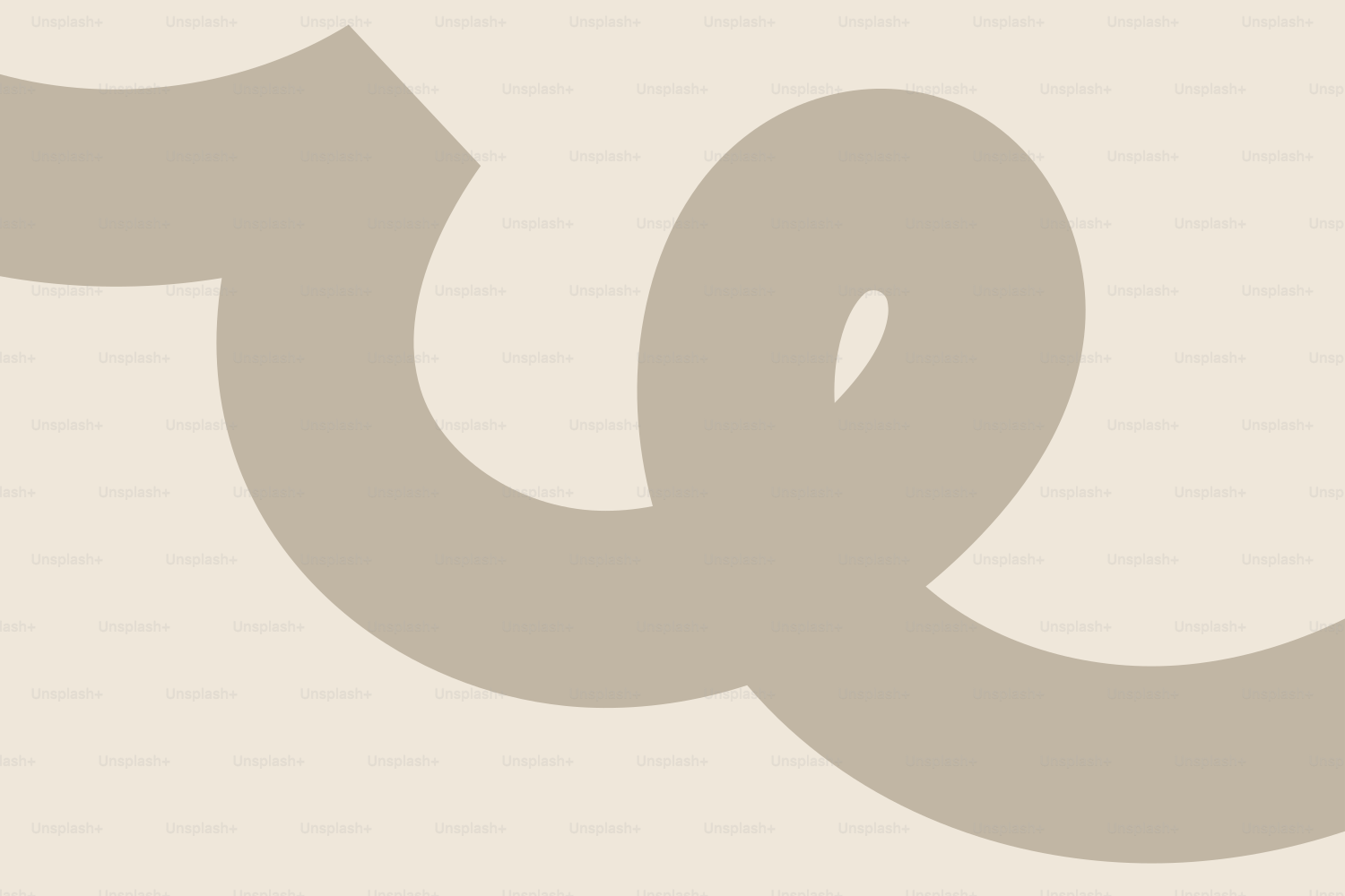 A beige ribbon on a cream background