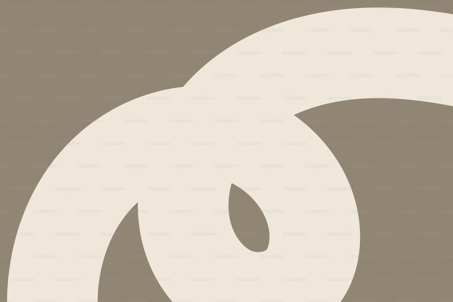 Abstract beige swirl on taupe background