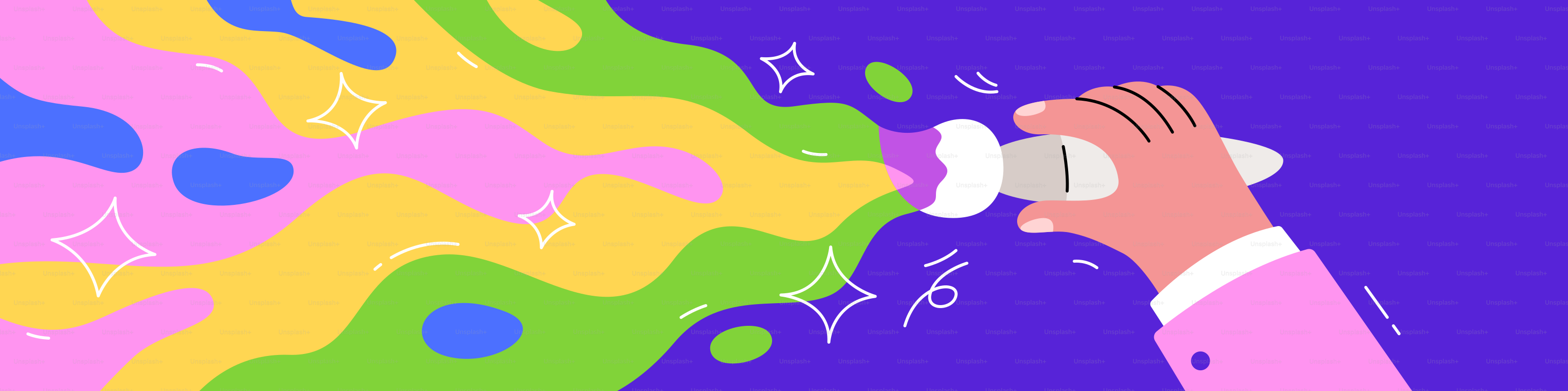 Hand spraying colorful paint on purple background