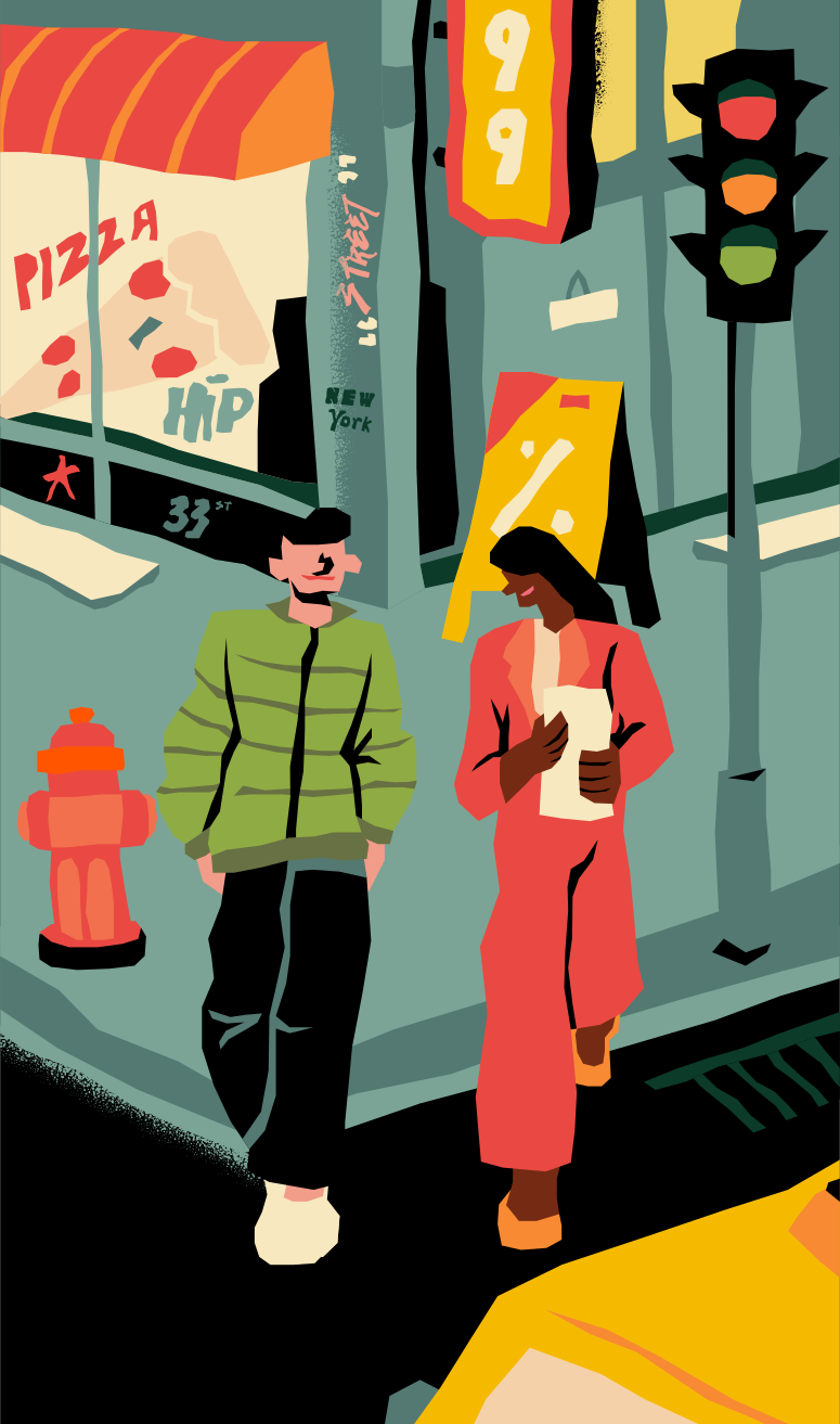 Two people walking on a city street at night