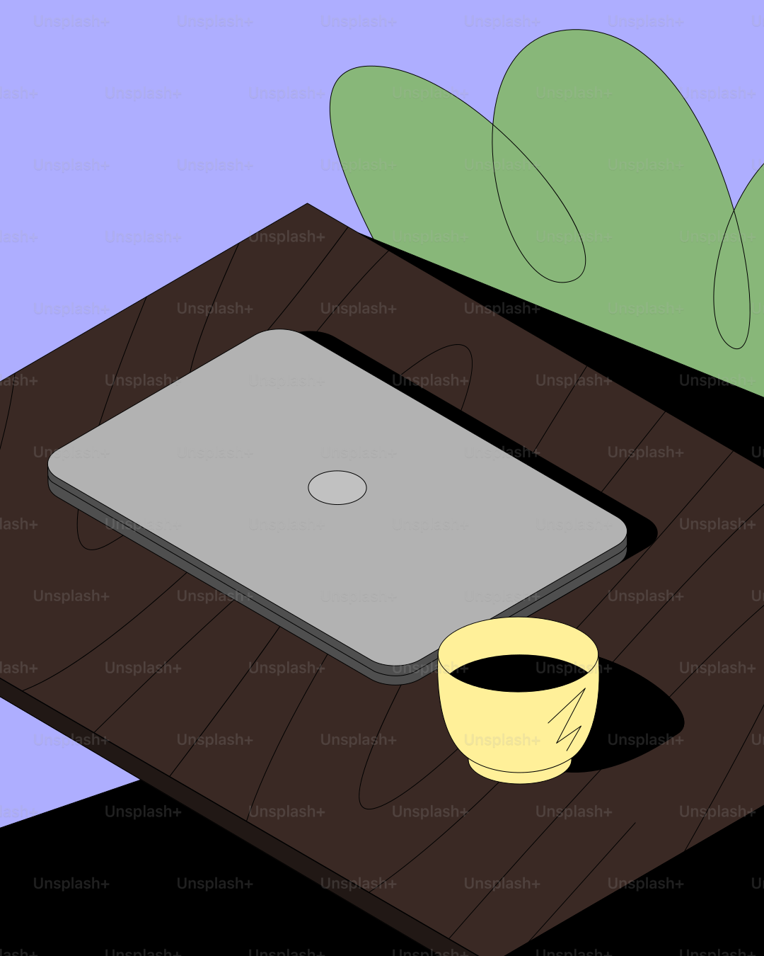 木製の机の上に置かれたノートパソコンとコーヒーカップ。