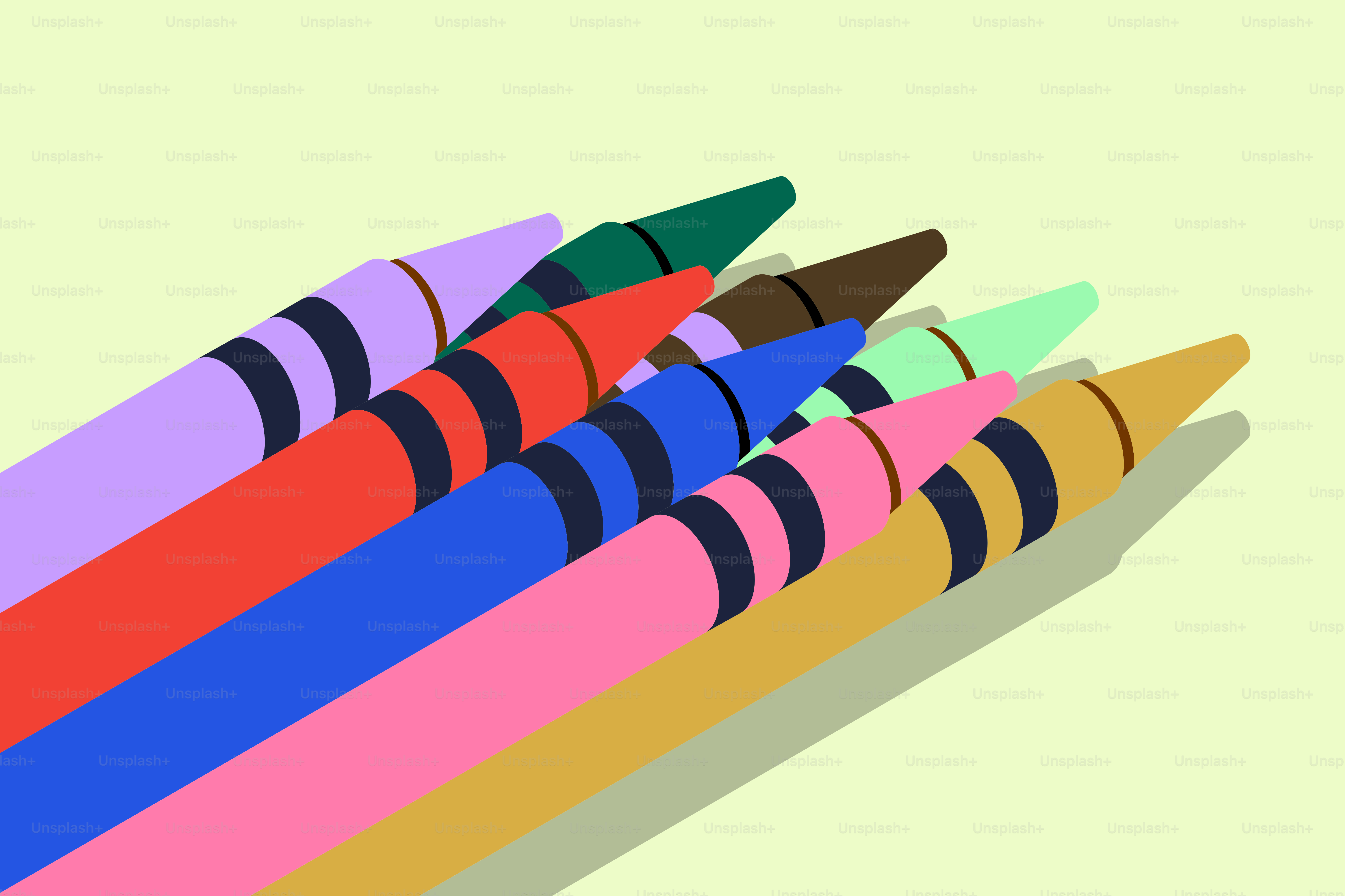 Diversi pastelli colorati disposti diagonalmente su uno sfondo verde chiaro.