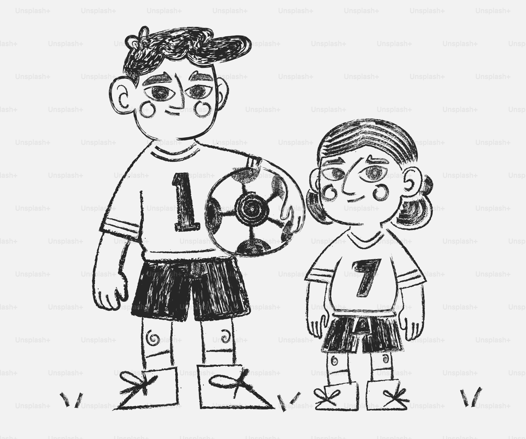 Dos niños con uniformes de fútbol y balón