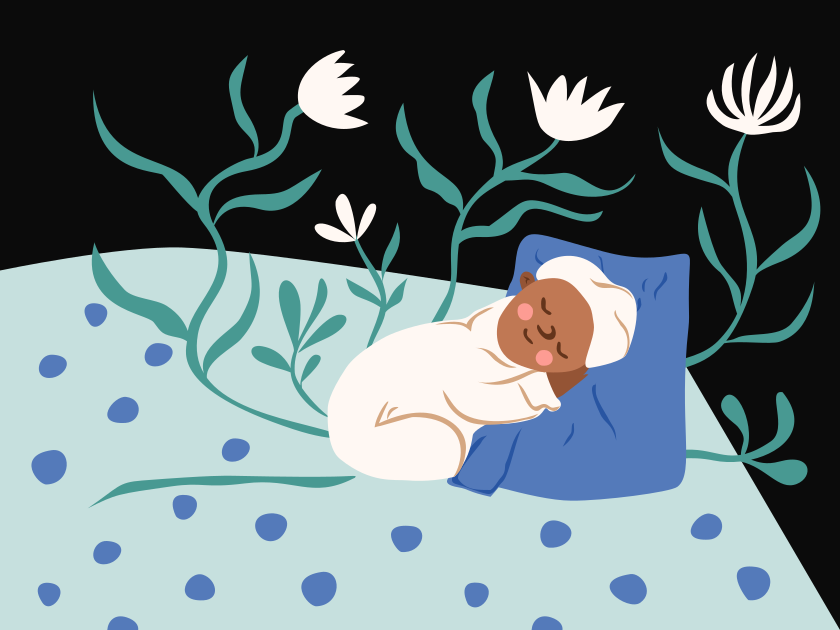 A baby sleeps peacefully surrounded by plants and flowers.