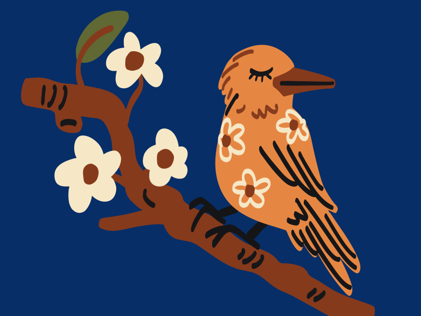 An orange bird with flowers sits on a branch.