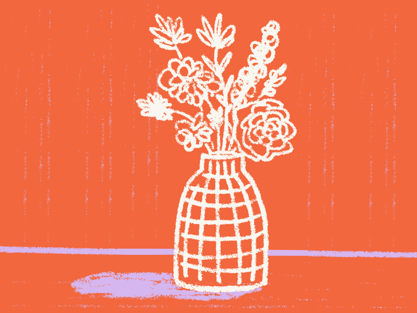 White floral arrangement in a grid vase on orange background