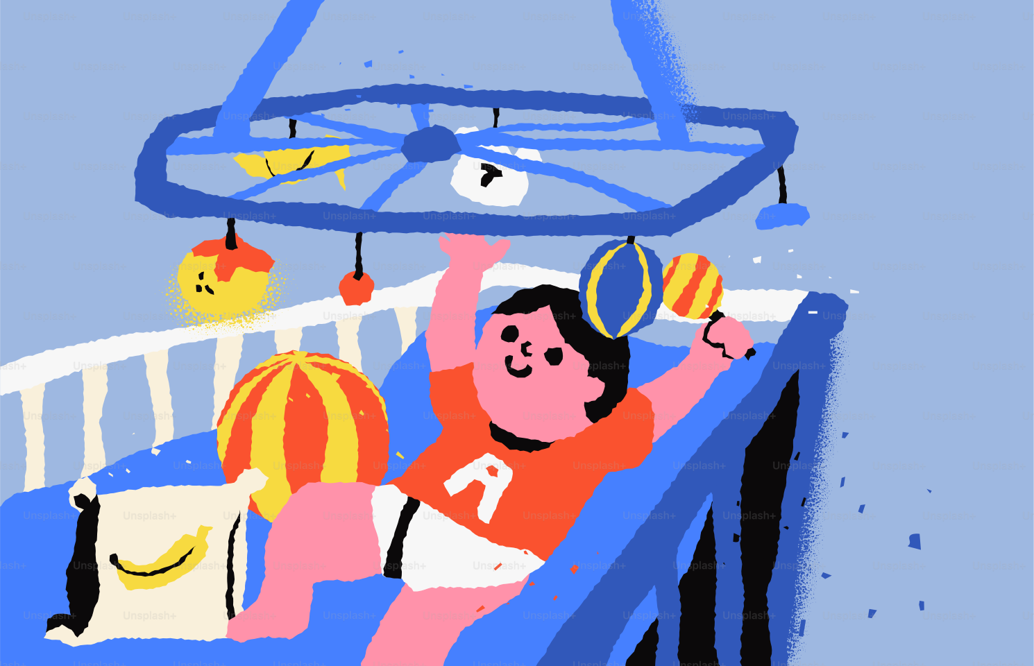 Baby playing with mobile and toys in crib