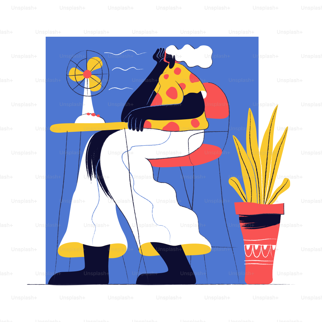 Person sitting at desk with fan blowing