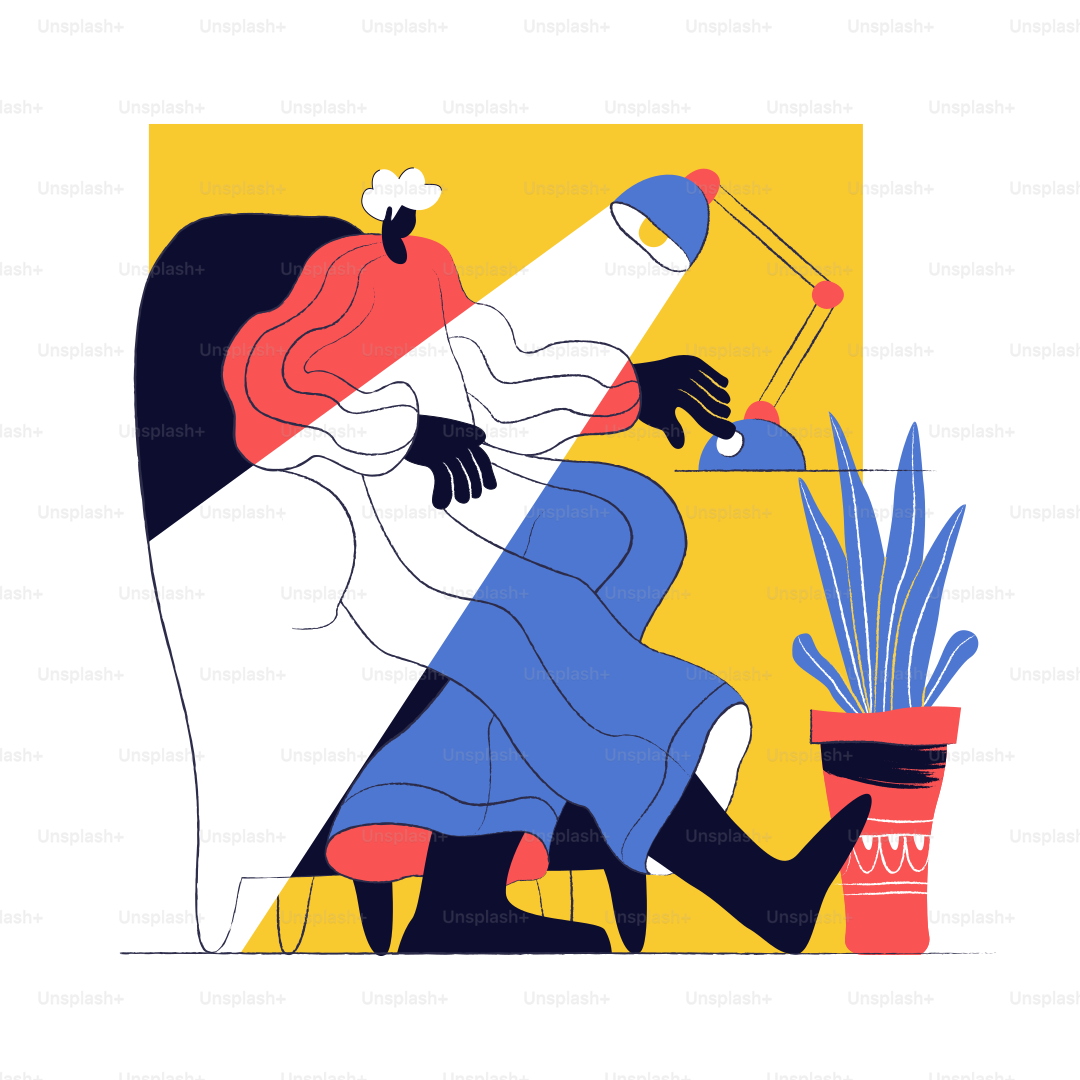 Person sitting at desk with lamp illuminating work