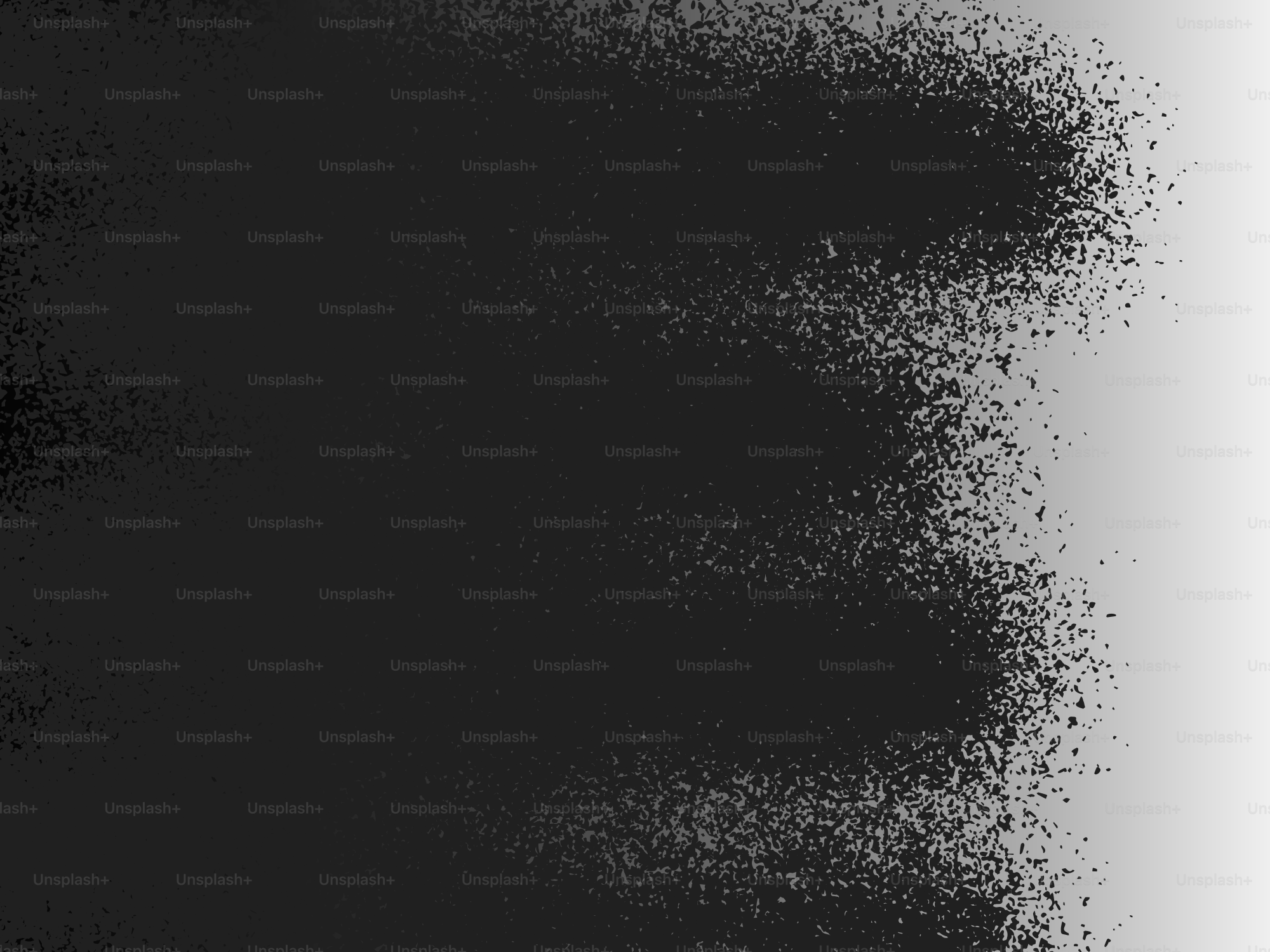 A dark, textured spray paint effect on a white background