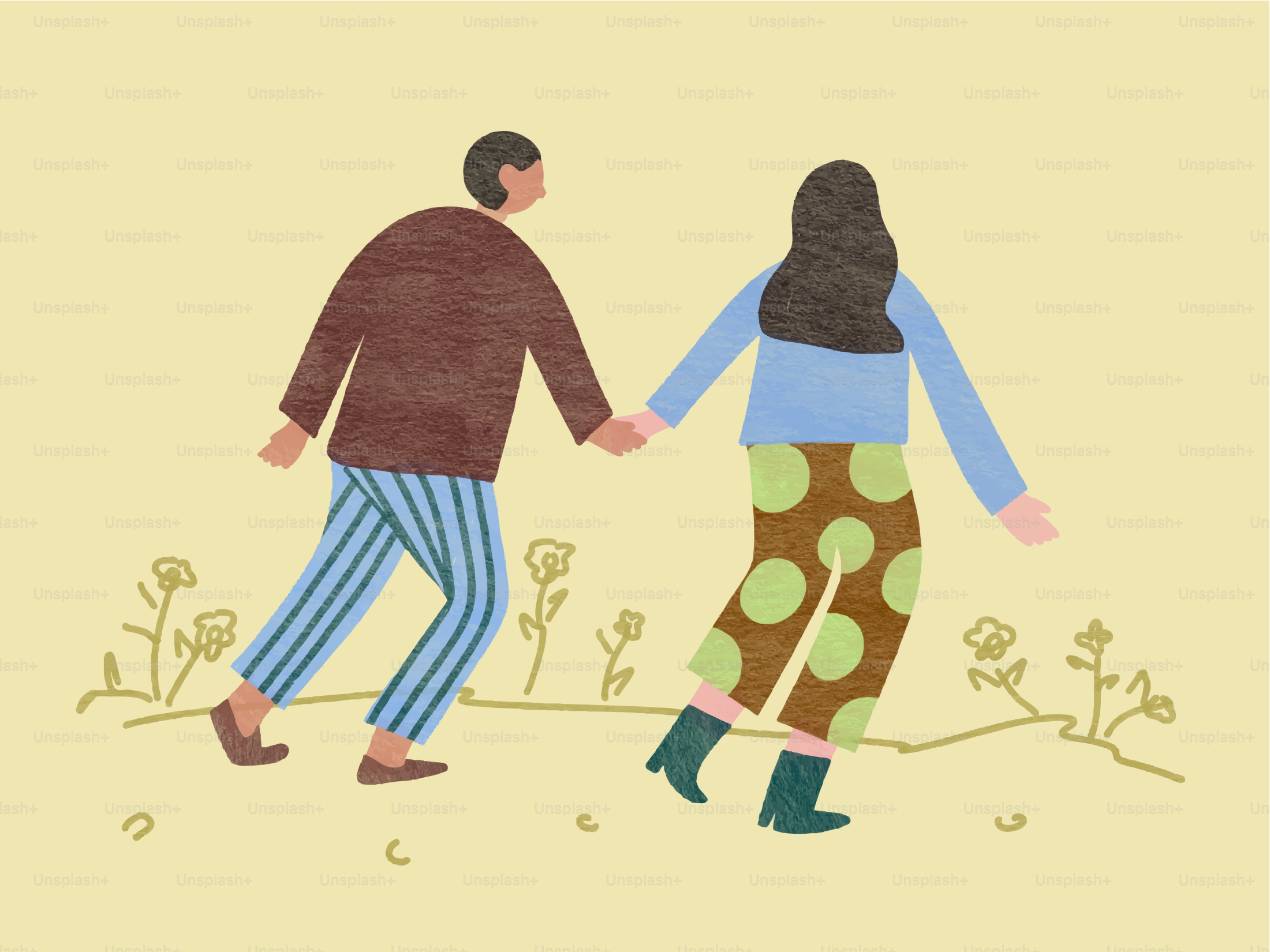 Couple holding hands walking through a field