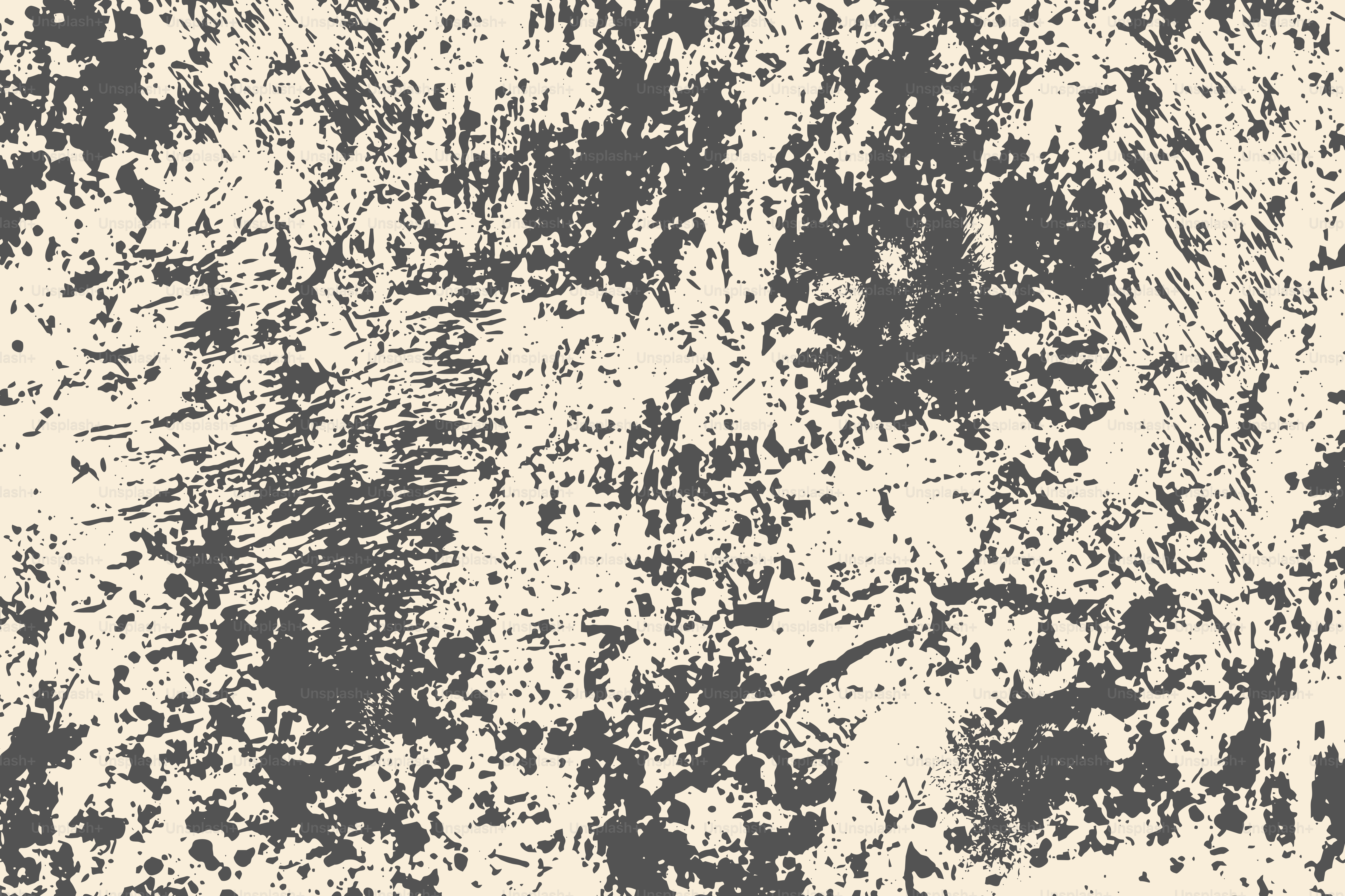 Textured abstract background with dark splatters on cream.