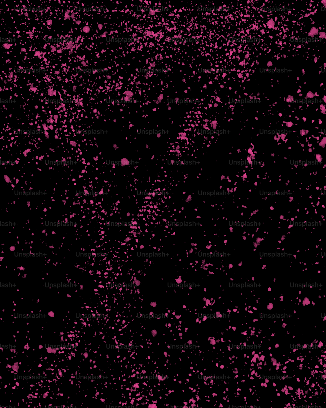 Puntos rosas dispersos sobre un fondo negro.