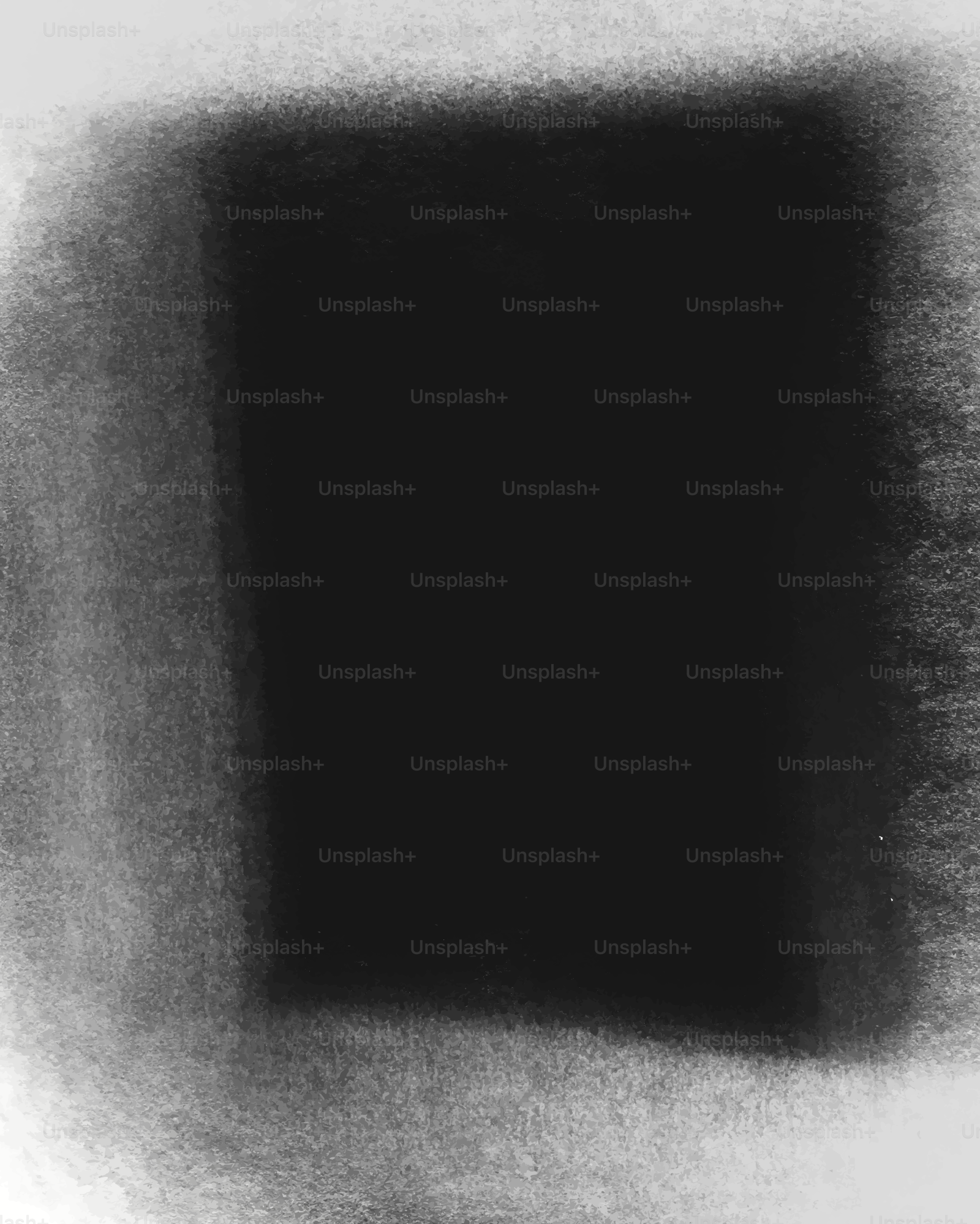 A dark rectangular shape on a textured background