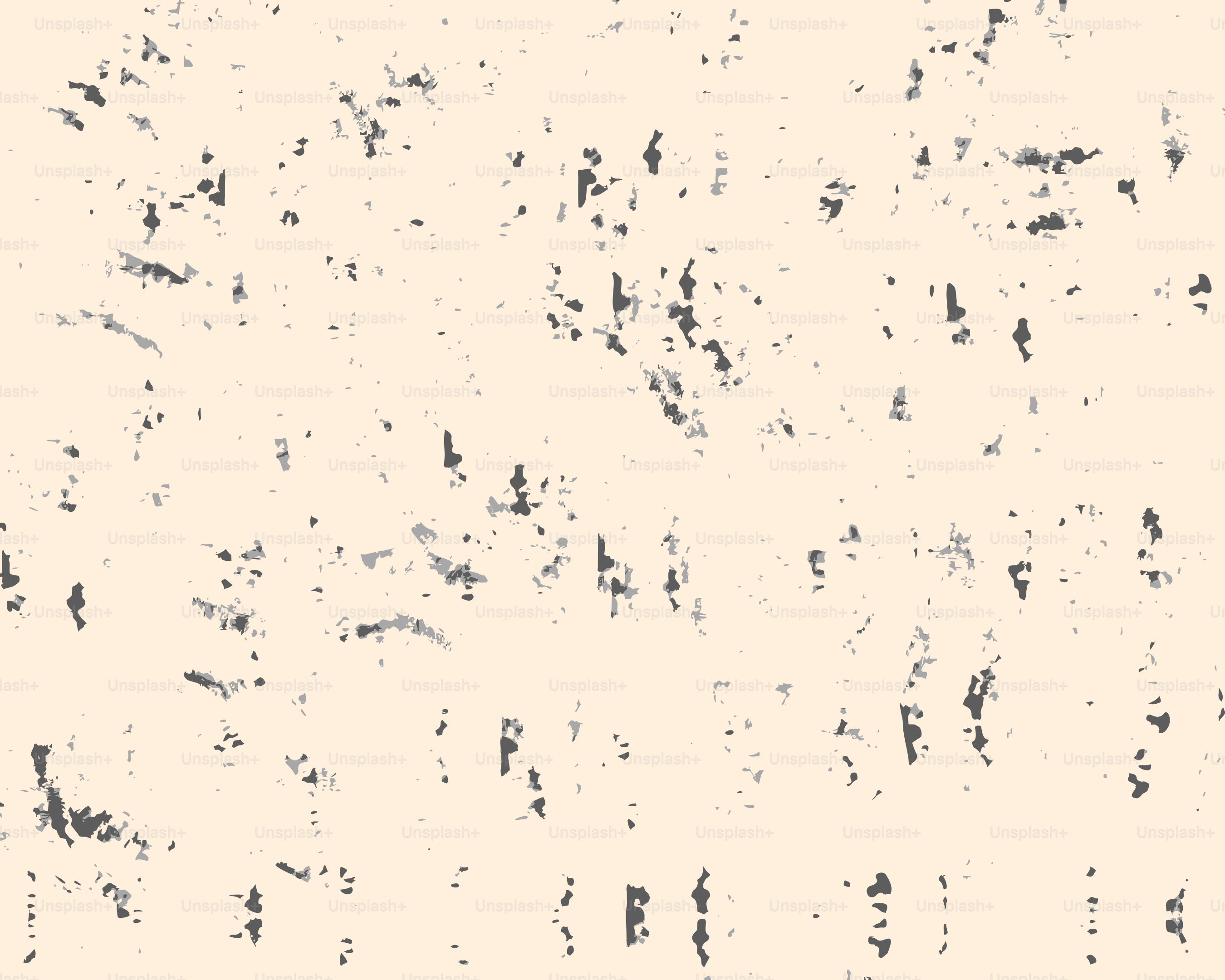 A light beige background with dark speckles.